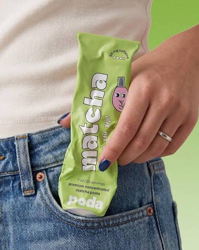 Poda matcha stir sip pouch held by a consumer